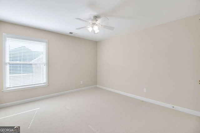 carpeted empty room featuring ceiling fan