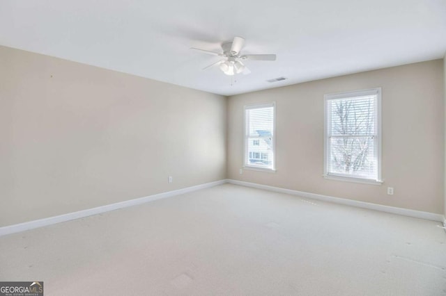 carpeted empty room featuring ceiling fan