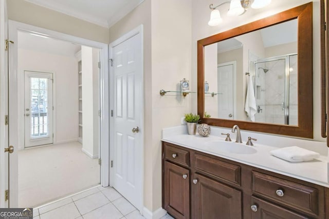 bathroom with tile patterned floors, vanity, an enclosed shower, and ornamental molding