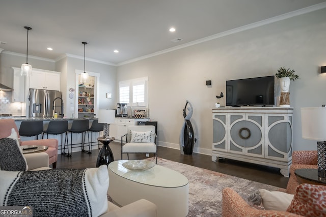 living room with crown molding and dark hardwood / wood-style floors