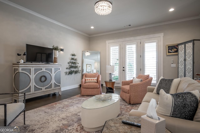 living room featuring an inviting chandelier, crown molding, and dark hardwood / wood-style floors