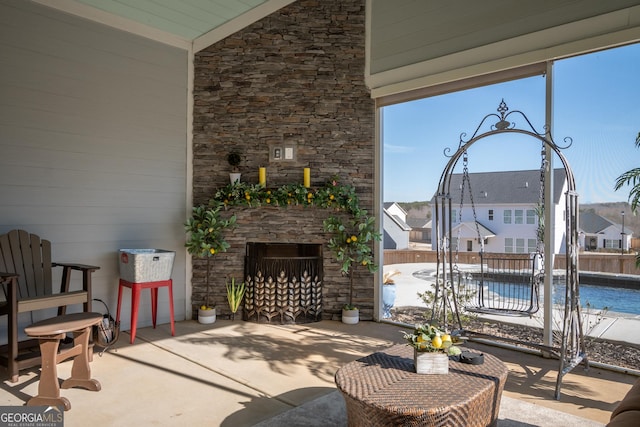 view of patio with a fenced in pool and an outdoor stone fireplace