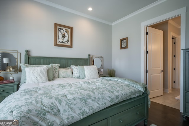 bedroom featuring ornamental molding and hardwood / wood-style floors