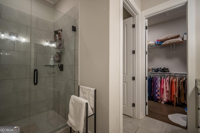 bathroom with tile patterned flooring and walk in shower