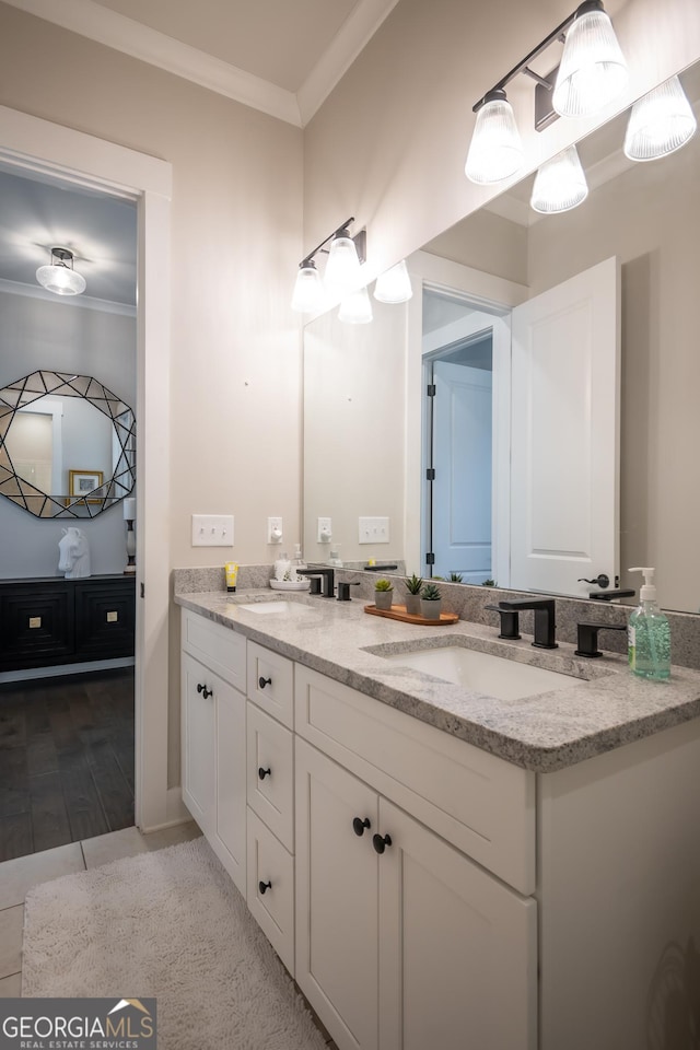 bathroom with vanity, wood-type flooring, and ornamental molding