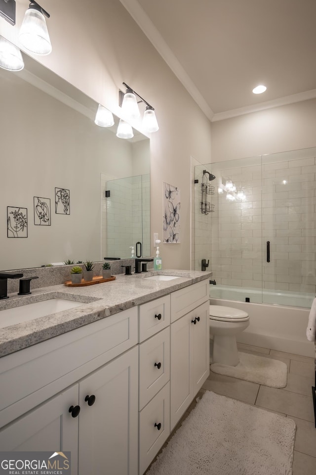 full bathroom featuring ornamental molding, vanity, and bath / shower combo with glass door