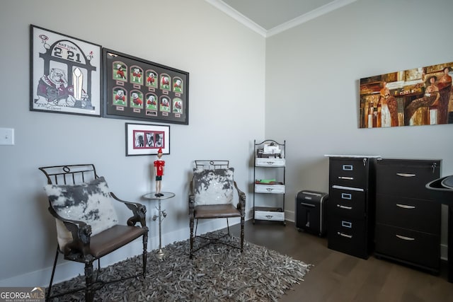 sitting room with dark wood-type flooring and ornamental molding