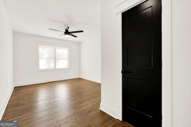 spare room featuring ceiling fan and dark hardwood / wood-style flooring