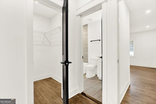 bathroom with wood-type flooring and toilet