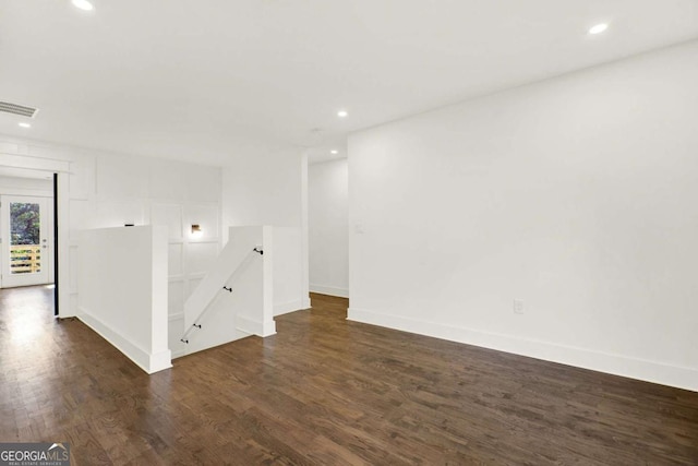 spare room with dark wood-type flooring