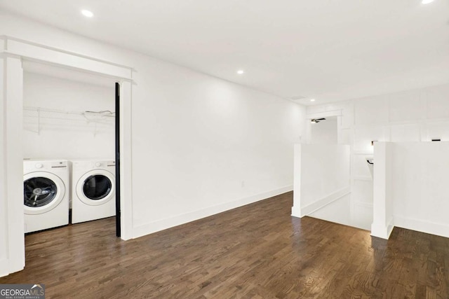 laundry area with dark hardwood / wood-style floors and washing machine and clothes dryer