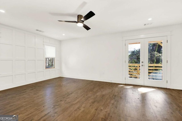 empty room with dark wood-type flooring, ceiling fan, and french doors