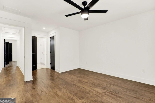 spare room featuring dark wood-type flooring and ceiling fan