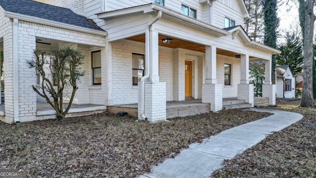 view of exterior entry with covered porch