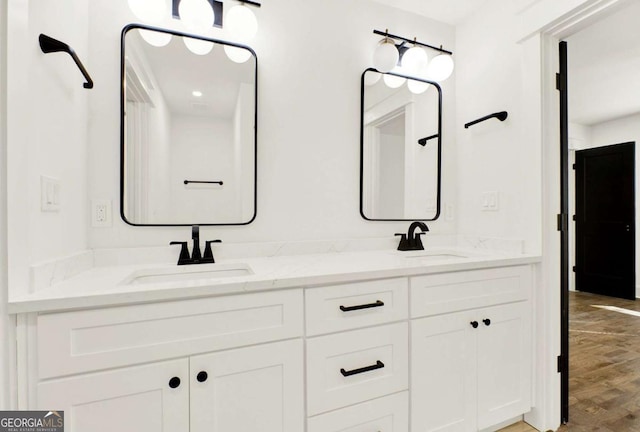 bathroom with hardwood / wood-style flooring and vanity