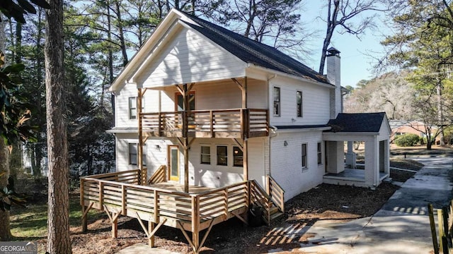 rear view of property with a balcony