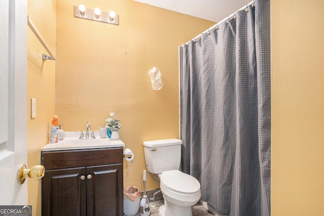 bathroom with vanity, curtained shower, and toilet