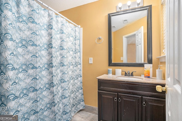 bathroom featuring vanity and a textured ceiling