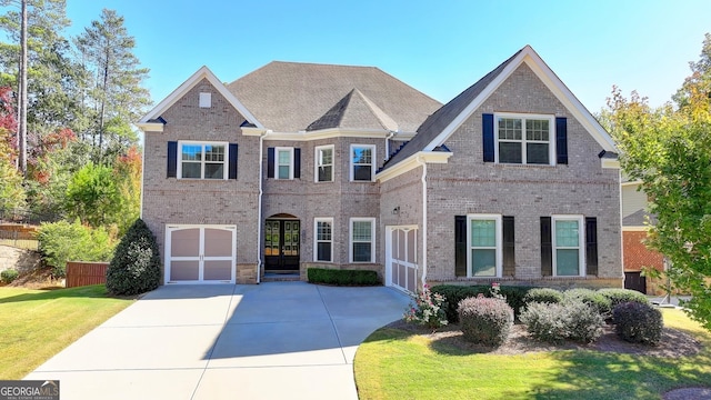 view of front of home with a garage and a front lawn