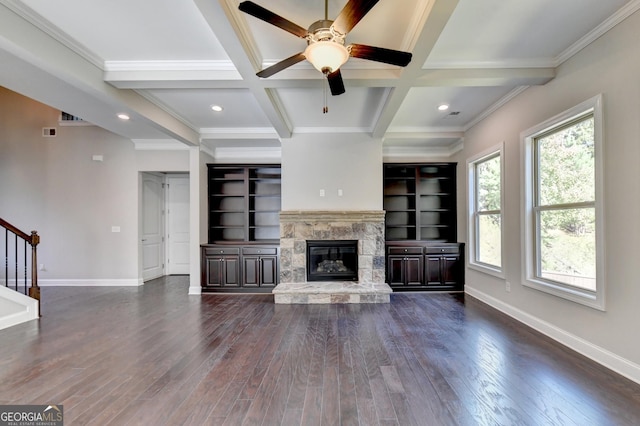 unfurnished living room with beamed ceiling, a fireplace, coffered ceiling, and dark hardwood / wood-style flooring