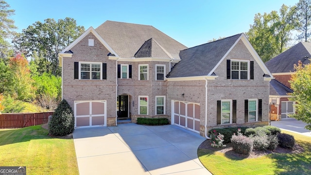 view of front facade with a garage and a front lawn