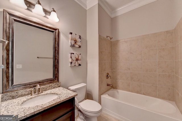 full bathroom featuring crown molding, vanity, toilet, and tiled shower / bath combo