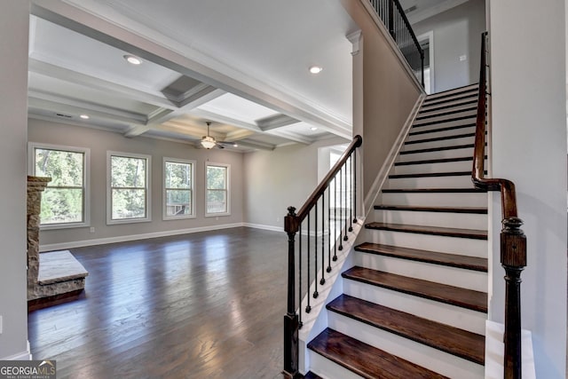 staircase featuring coffered ceiling, ornamental molding, beamed ceiling, ceiling fan, and hardwood / wood-style floors