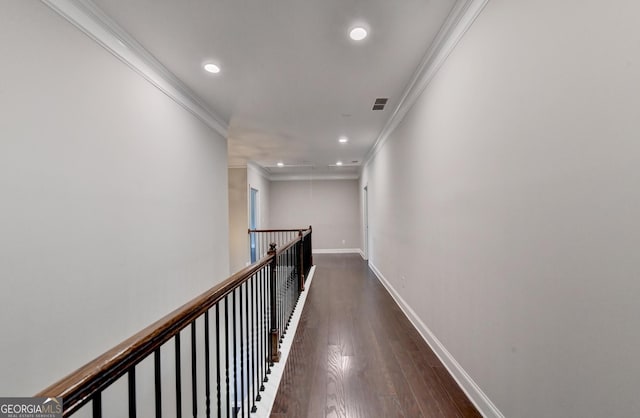 corridor with ornamental molding and dark hardwood / wood-style floors