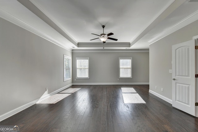 spare room with crown molding, dark hardwood / wood-style floors, ceiling fan, and a tray ceiling