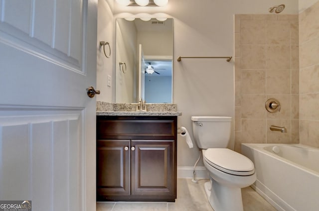 full bathroom featuring tiled shower / bath, vanity, and toilet