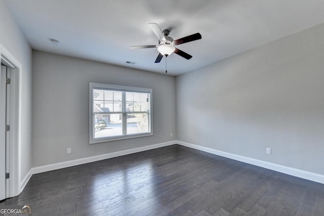 unfurnished room featuring dark wood-type flooring and ceiling fan