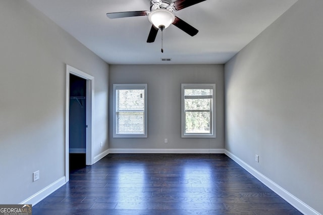 unfurnished bedroom featuring dark hardwood / wood-style floors, ceiling fan, and a closet