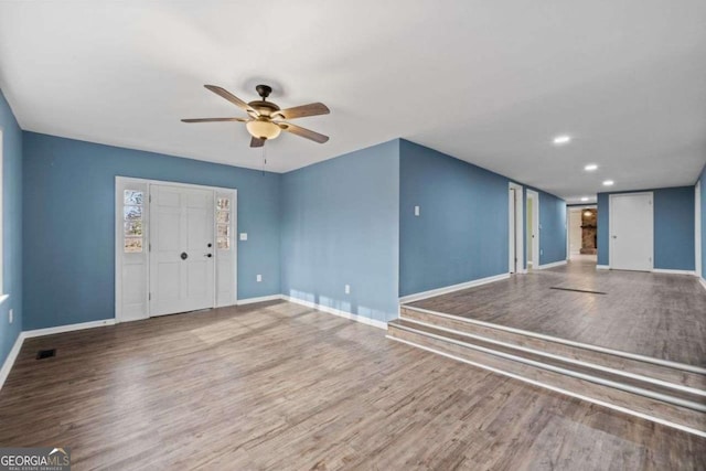 unfurnished room featuring hardwood / wood-style flooring and ceiling fan