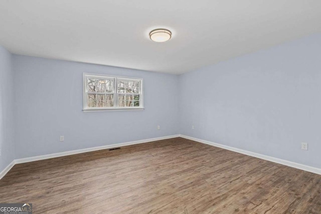 empty room featuring hardwood / wood-style floors