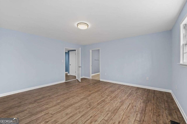 unfurnished room featuring hardwood / wood-style flooring