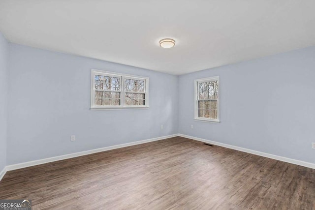 unfurnished room with wood-type flooring