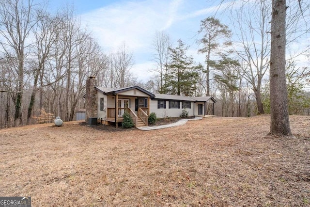 single story home with a porch and central air condition unit