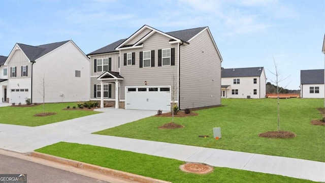 view of front of property with a garage and a front lawn