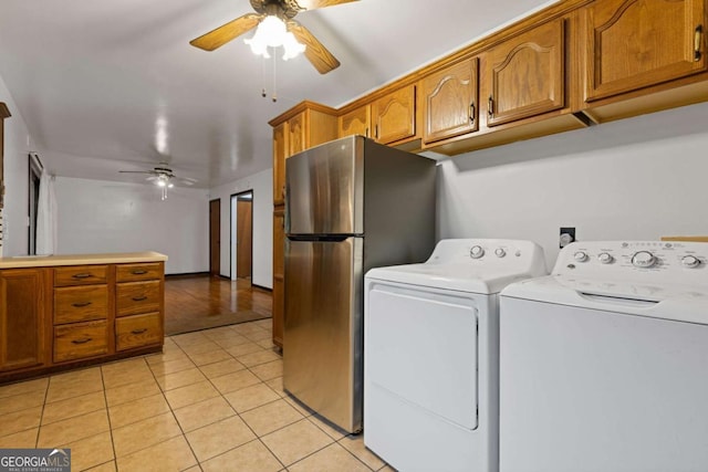 laundry area with separate washer and dryer, light tile patterned floors, and ceiling fan