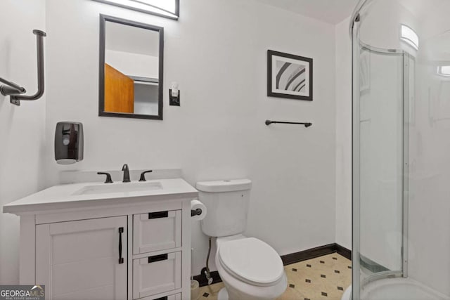 bathroom with vanity, an enclosed shower, and toilet