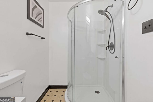 bathroom featuring an enclosed shower and toilet