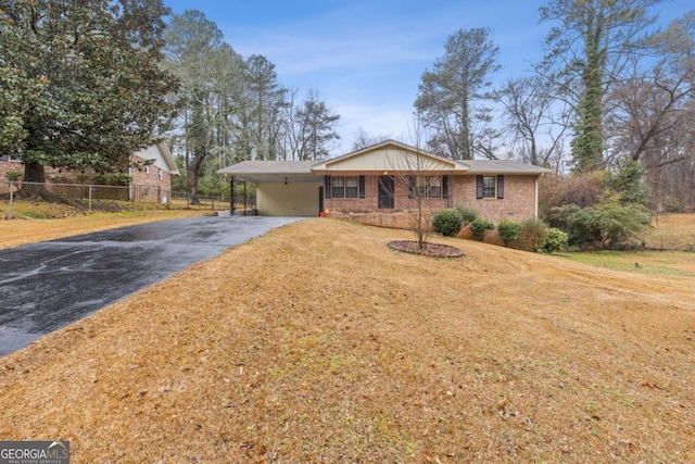 single story home featuring a carport and a front yard