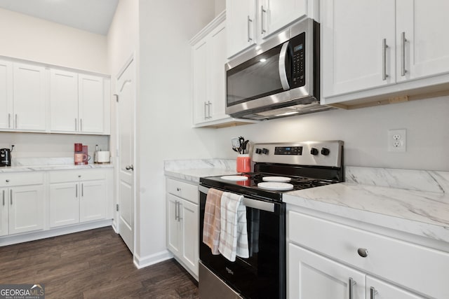 kitchen with stainless steel appliances, light stone counters, white cabinets, and dark hardwood / wood-style flooring