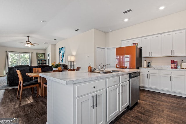 kitchen featuring sink, dishwasher, refrigerator, an island with sink, and white cabinets