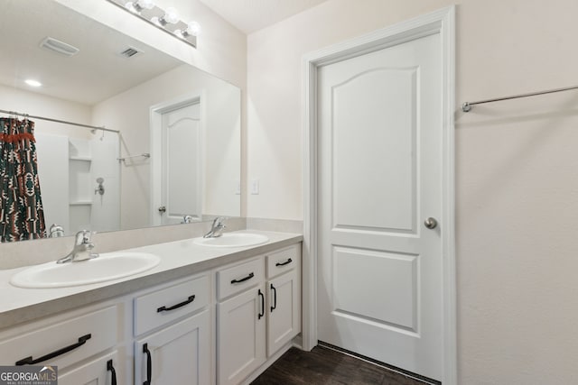 bathroom with vanity, hardwood / wood-style floors, and curtained shower