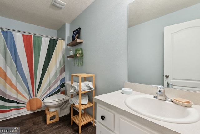 bathroom featuring toilet, a shower with curtain, a textured ceiling, vanity, and hardwood / wood-style floors