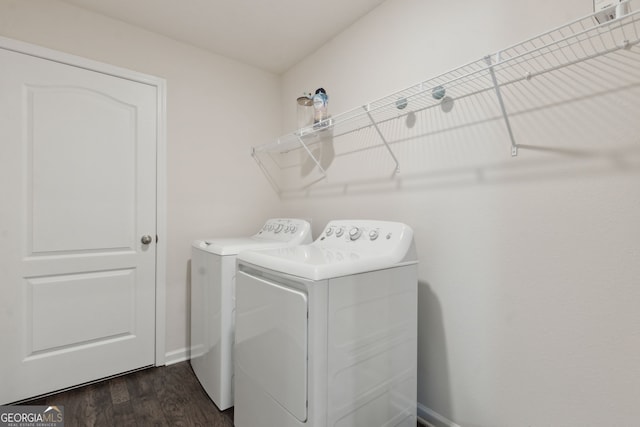 laundry room featuring dark hardwood / wood-style flooring and washer and clothes dryer