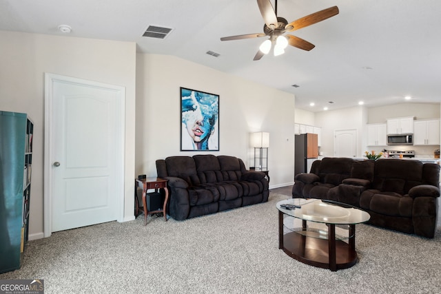 carpeted living room with vaulted ceiling and ceiling fan