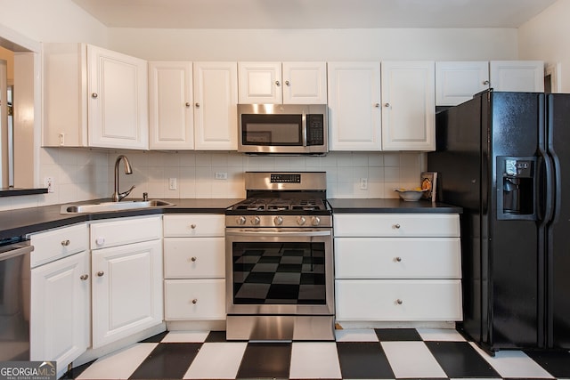 kitchen with stainless steel appliances, sink, decorative backsplash, and white cabinets