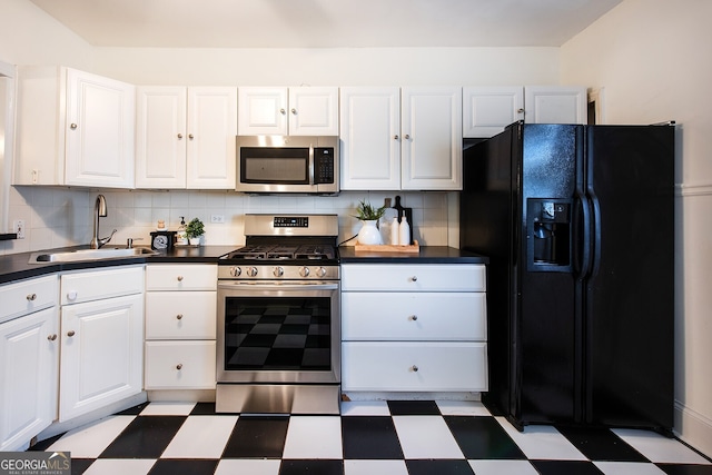 kitchen with backsplash, appliances with stainless steel finishes, sink, and white cabinets